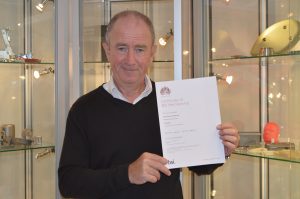 MD Christopher Dean holding BSI Certificate of Membership