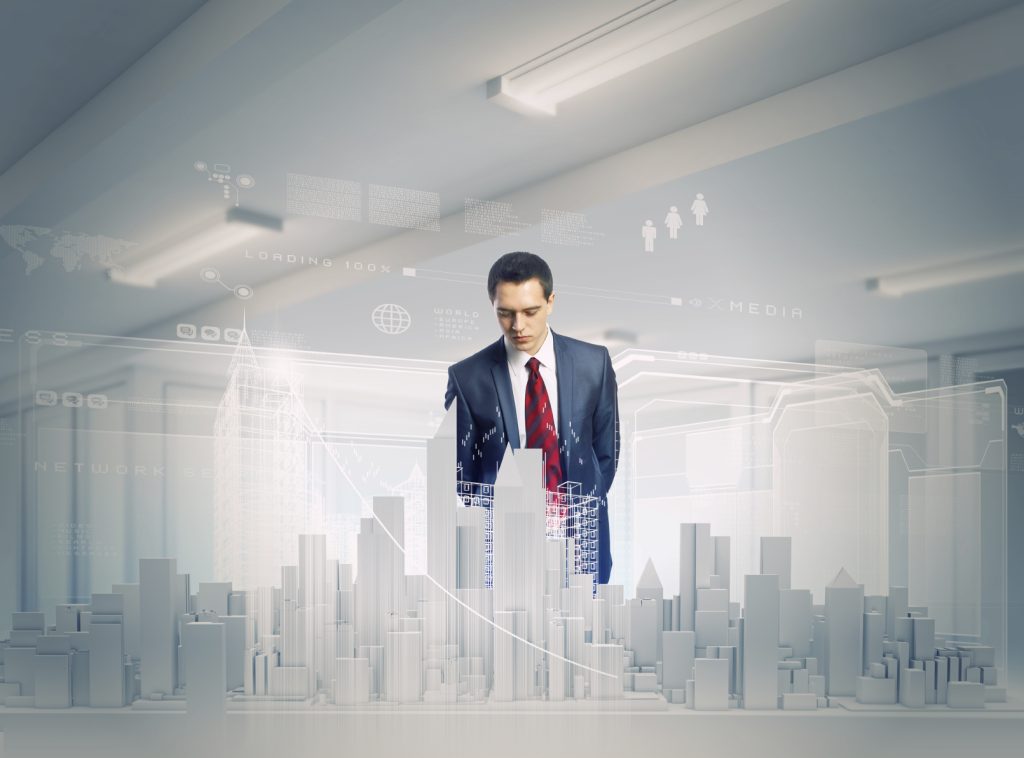 Young businessman examining model of construction project