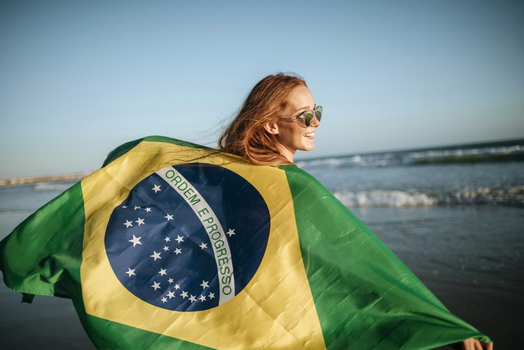 girl in sunglasses with Brazilian flag