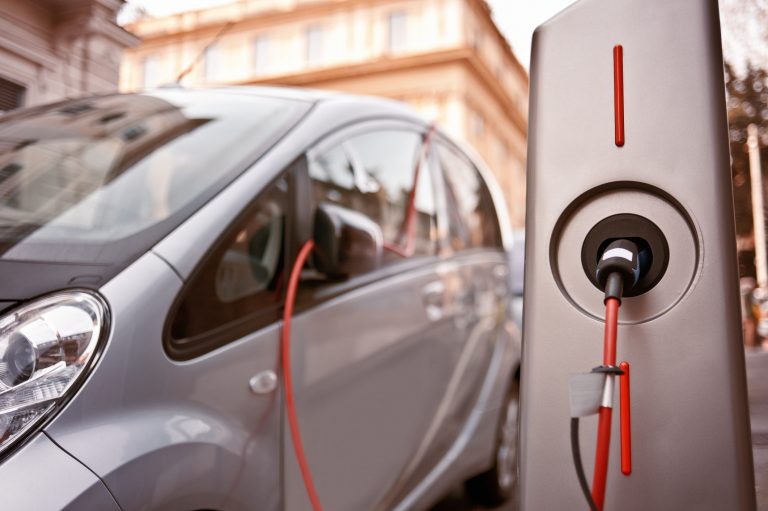 An electric car in charging on the street