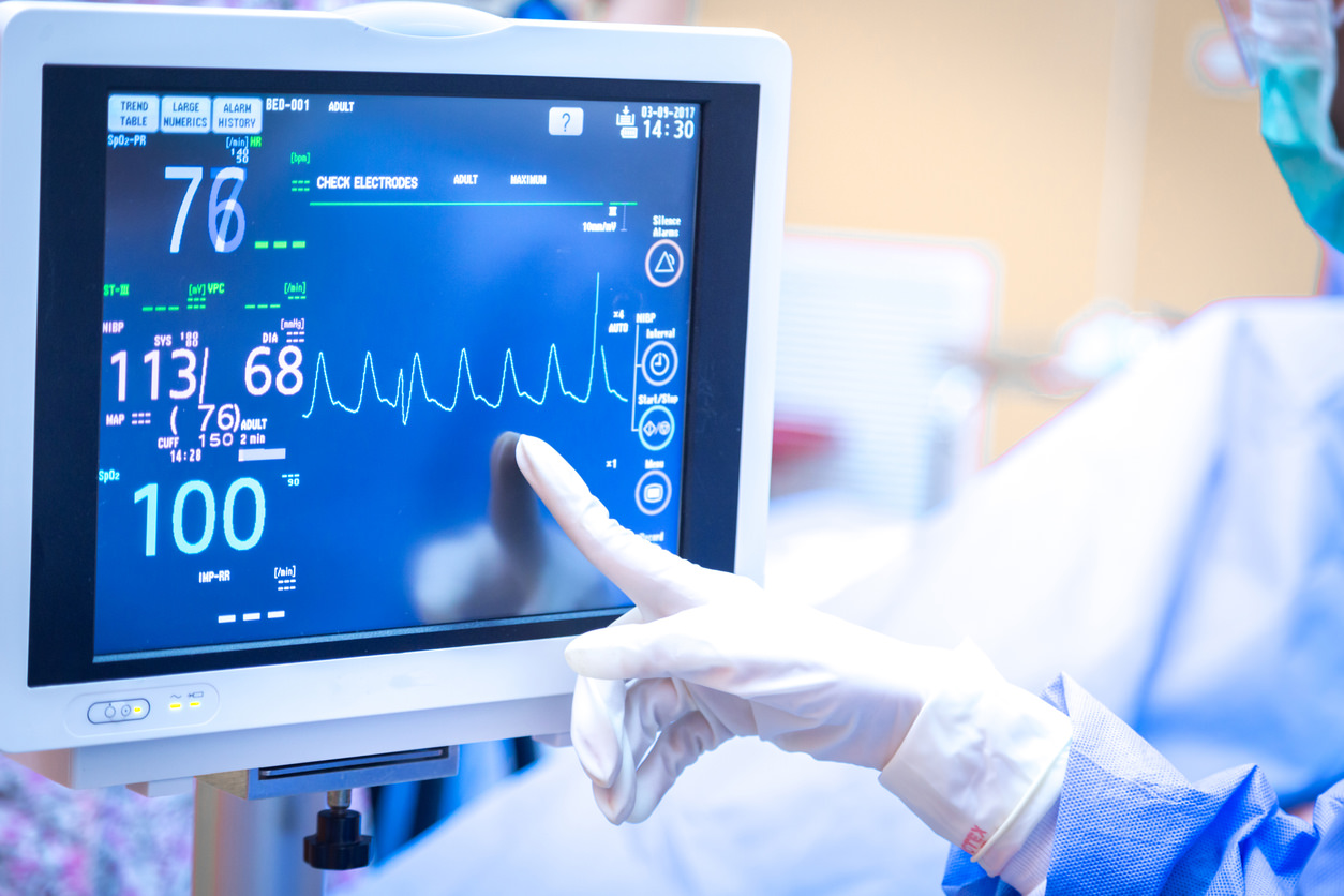 Female surgeon using monitor in operating room.