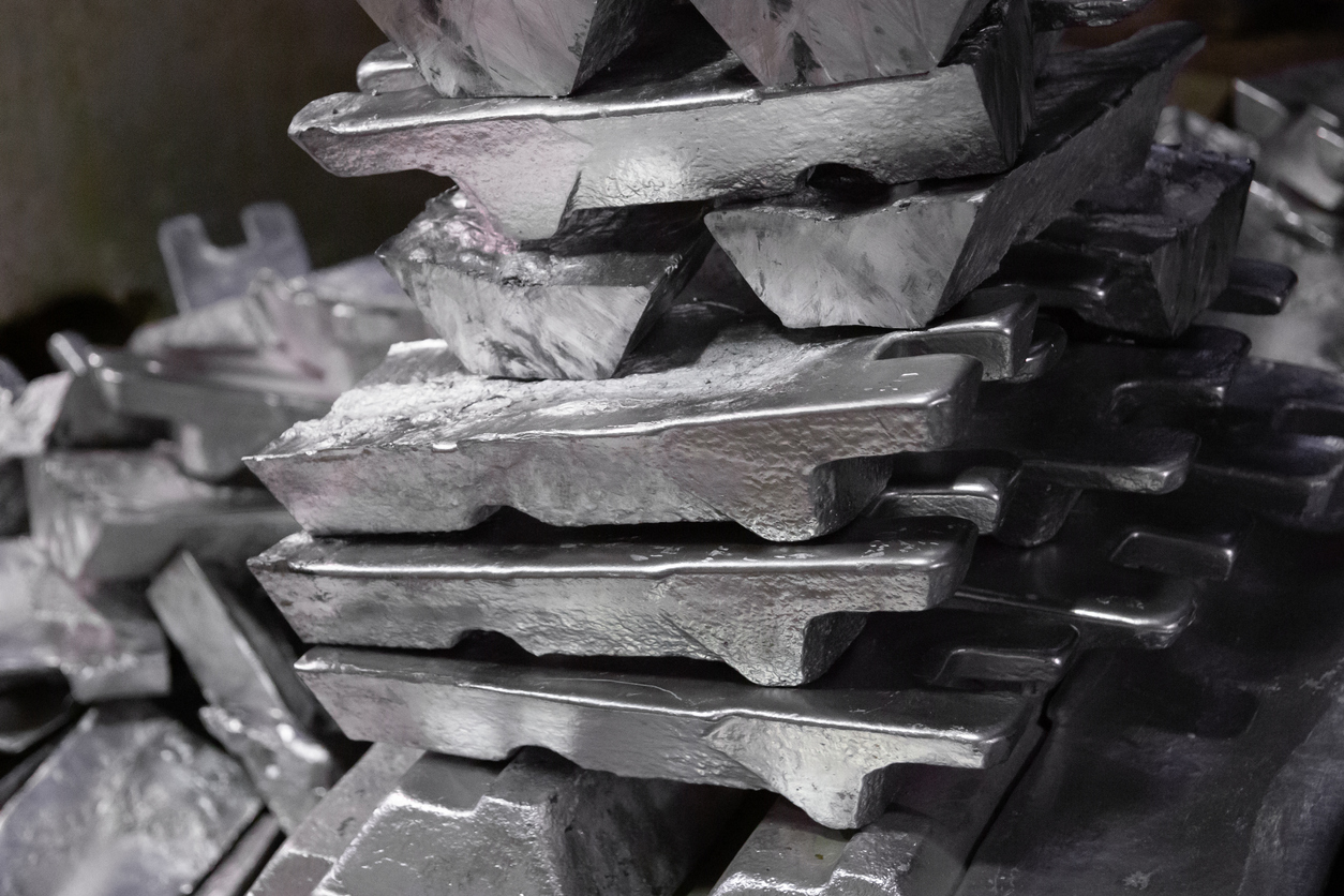 messy stack of aluminium ingots - close-up with selective focus