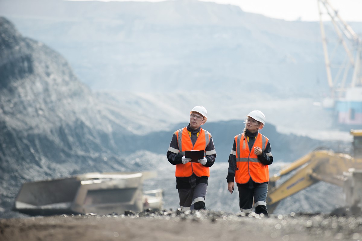 Two men walking around a mine