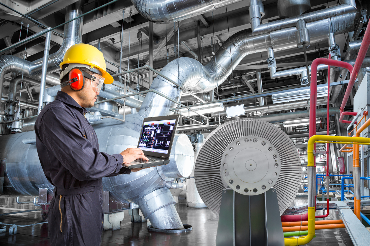 Engineer using laptop computer for maintenance in thermal power