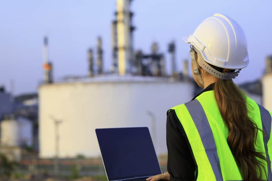 woman with a vest and a helmet in a nuclear plant